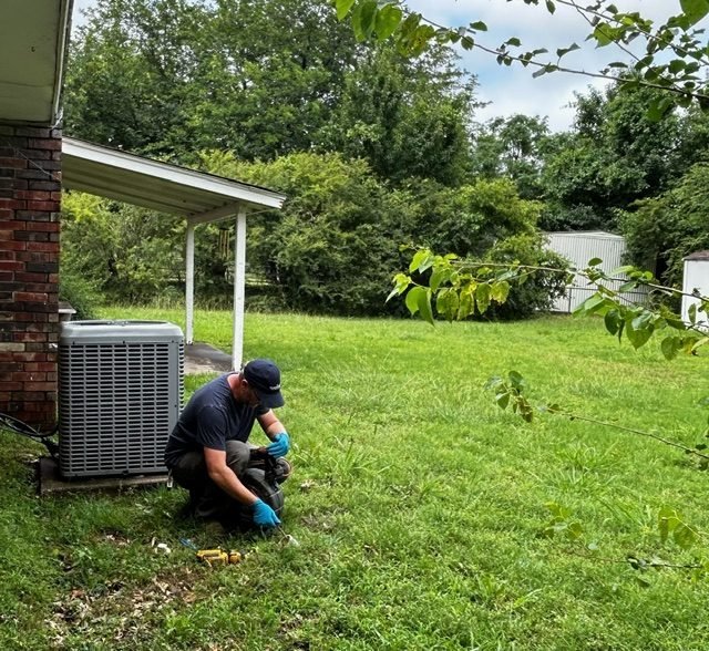 Titan Plumbing technician completing an outdoor plumbing repair near Durant Oklahoma